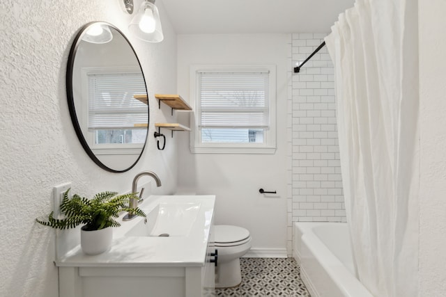 full bathroom with a healthy amount of sunlight, vanity, toilet, and shower / tub combo