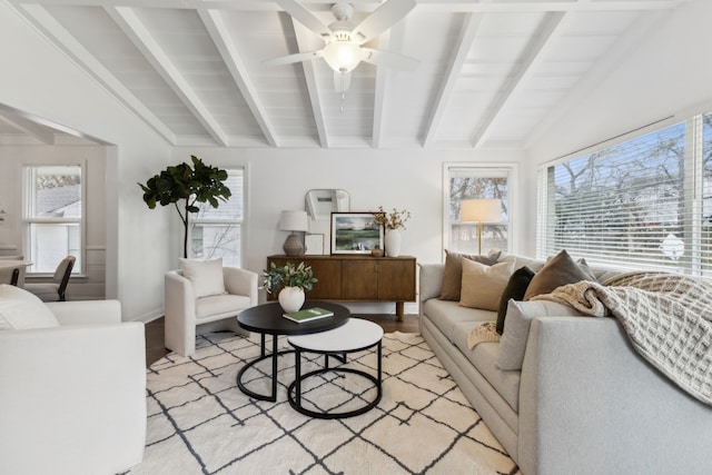 living room with lofted ceiling with beams, ceiling fan, and light wood-type flooring