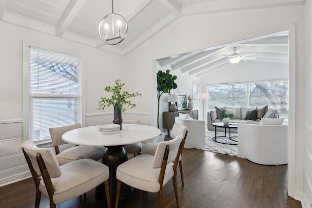 dining area featuring plenty of natural light, vaulted ceiling with beams, ceiling fan with notable chandelier, and dark hardwood / wood-style flooring