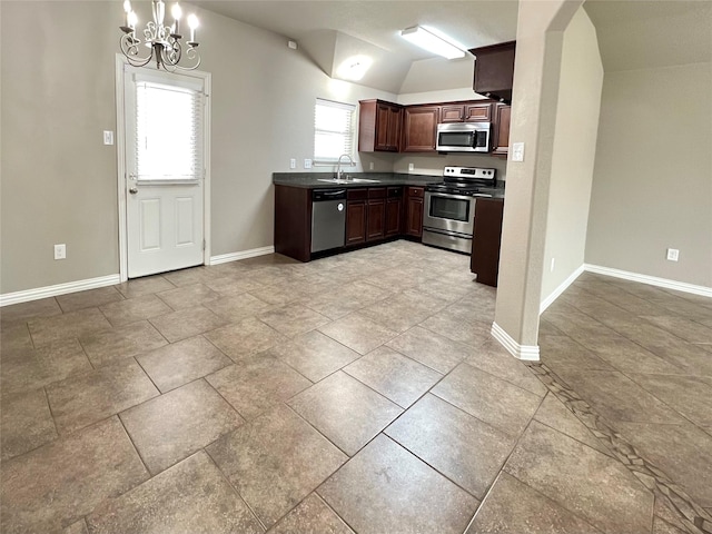 kitchen featuring lofted ceiling, sink, dark brown cabinets, hanging light fixtures, and appliances with stainless steel finishes