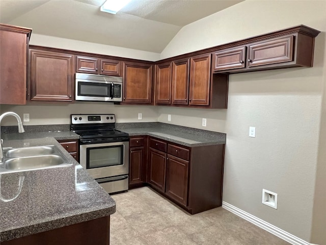 kitchen featuring sink, vaulted ceiling, and appliances with stainless steel finishes