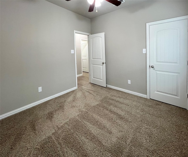 unfurnished bedroom with ceiling fan and carpet