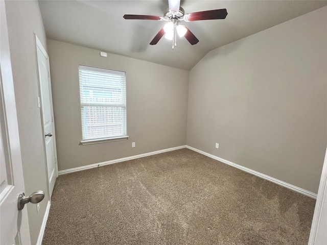 unfurnished room with ceiling fan, lofted ceiling, and carpet flooring