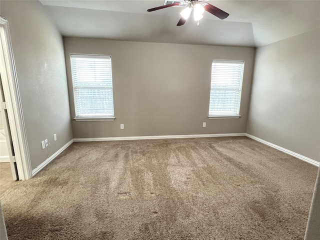 carpeted spare room featuring ceiling fan