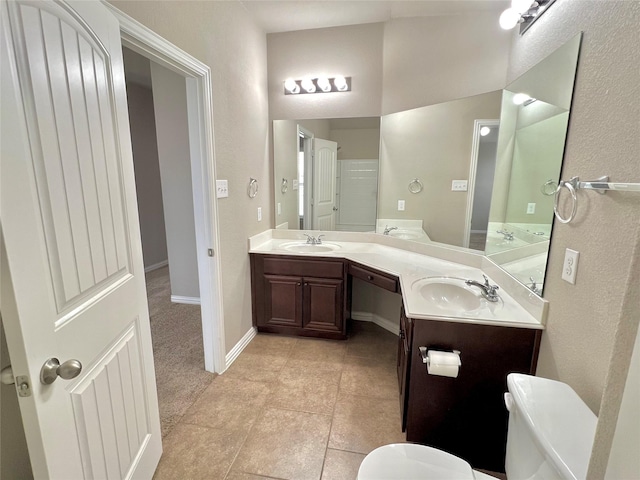 bathroom with tile patterned floors, vanity, and toilet