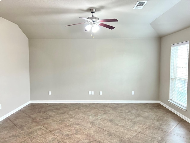 spare room featuring vaulted ceiling and ceiling fan