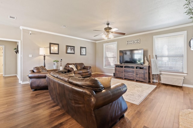 living room featuring hardwood / wood-style floors, ornamental molding, a wealth of natural light, and ceiling fan