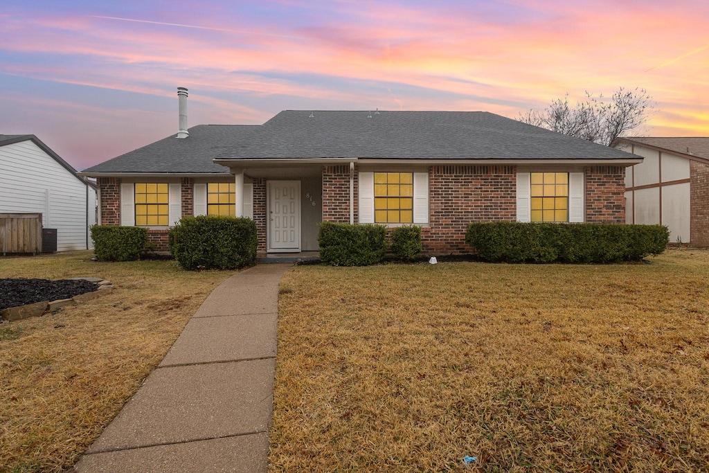 ranch-style house with a lawn