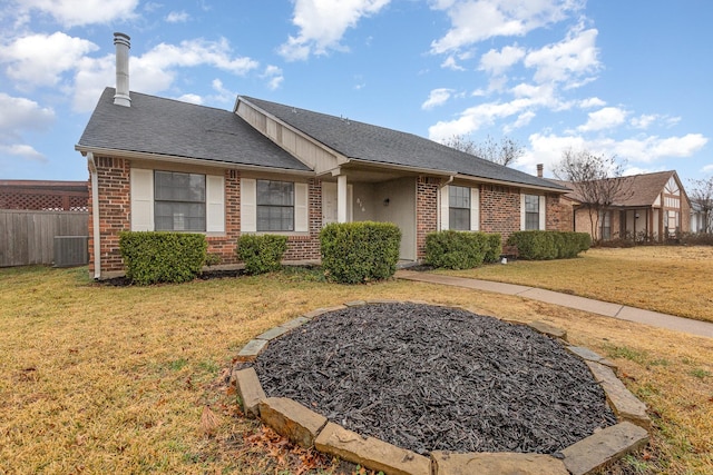 ranch-style home with cooling unit and a front yard