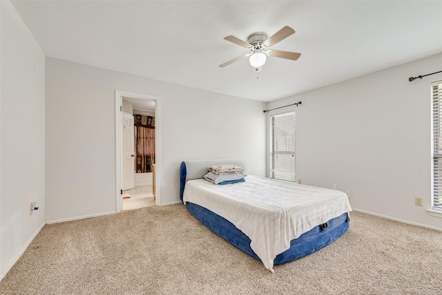 bedroom featuring carpet floors, connected bathroom, and ceiling fan