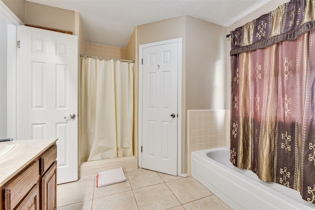 bathroom featuring vanity, tile patterned floors, a textured ceiling, and a shower with shower curtain