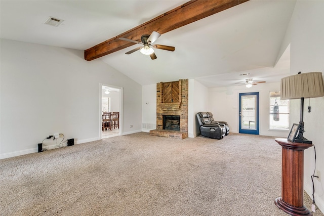 carpeted living room with a brick fireplace, vaulted ceiling with beams, and ceiling fan