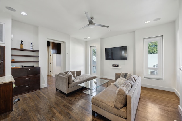 living room with ceiling fan, plenty of natural light, and dark hardwood / wood-style floors