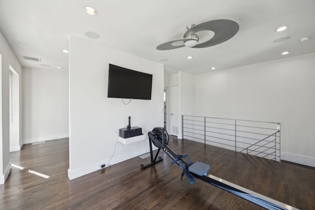 exercise room featuring dark wood-type flooring and ceiling fan