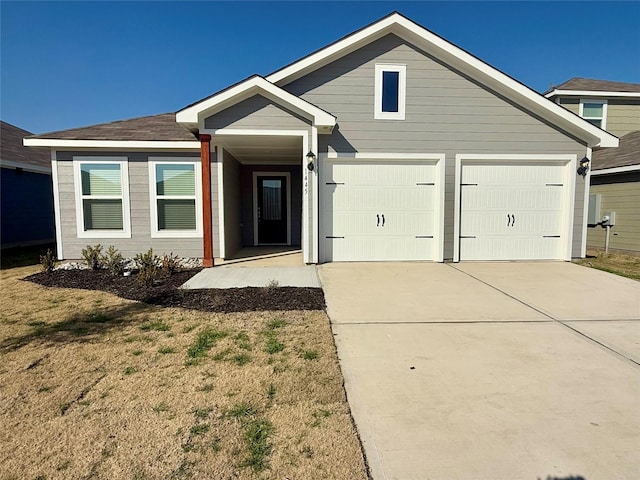 view of front of home featuring a garage and a front yard