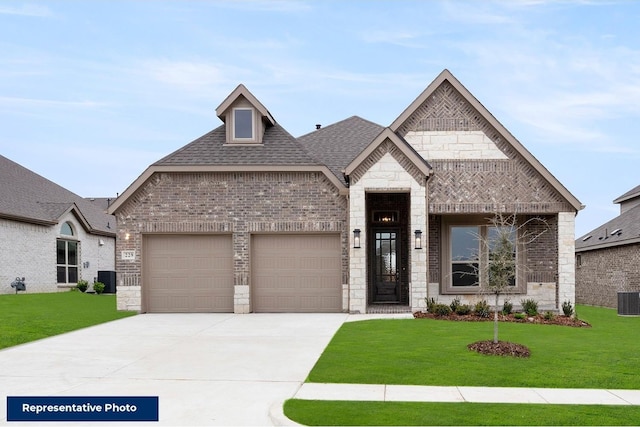 view of front of house featuring central AC unit, a garage, and a front lawn