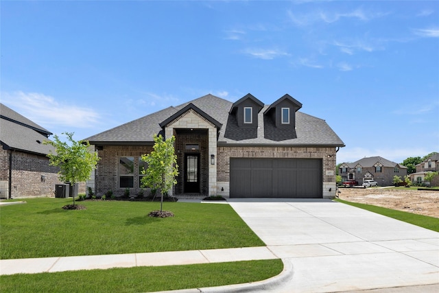 french country inspired facade with a garage, brick siding, driveway, and a shingled roof