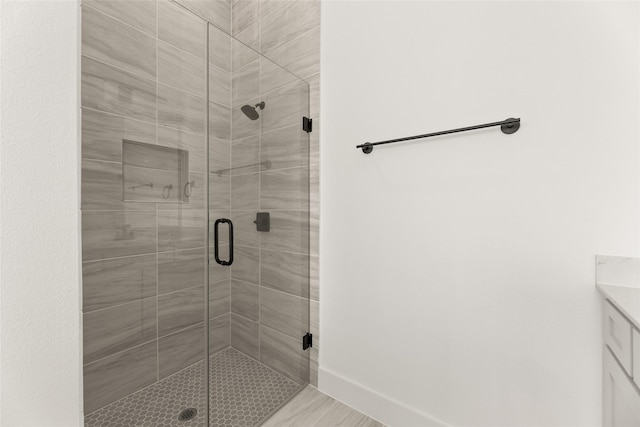 full bath featuring a stall shower and vanity