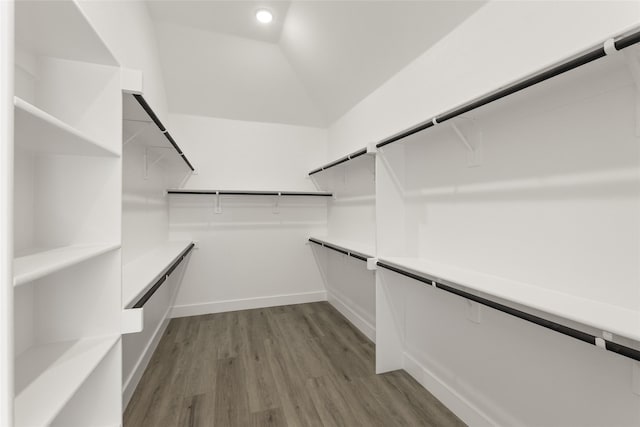 walk in closet with vaulted ceiling and wood finished floors
