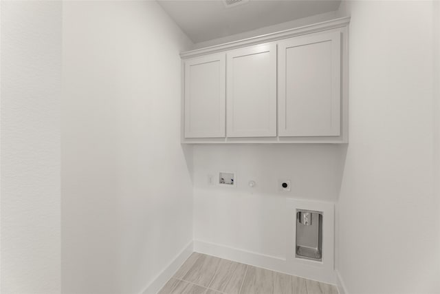washroom featuring electric dryer hookup, baseboards, gas dryer hookup, washer hookup, and cabinet space