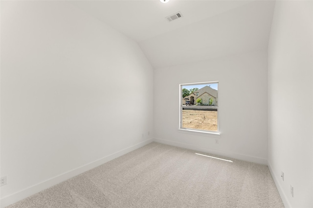 spare room featuring visible vents, baseboards, and light colored carpet