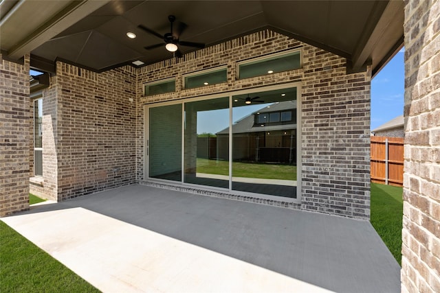 view of patio with ceiling fan and fence