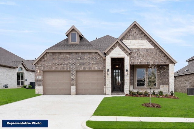 french provincial home featuring roof with shingles, a front yard, brick siding, a garage, and concrete driveway