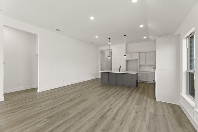 unfurnished living room with visible vents, light wood-style flooring, recessed lighting, and baseboards