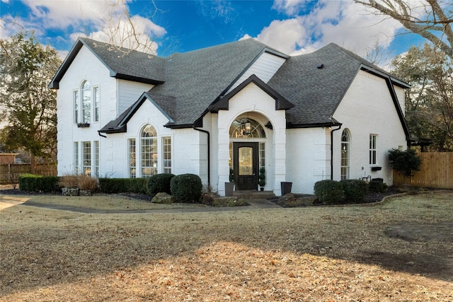 french provincial home featuring a front yard