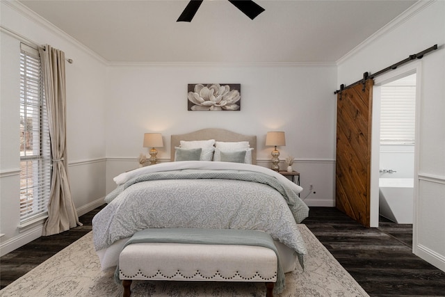 bedroom with ornamental molding, a barn door, dark wood-type flooring, and ceiling fan