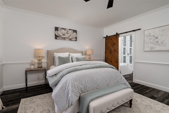 bedroom featuring crown molding, a barn door, dark hardwood / wood-style floors, and ceiling fan