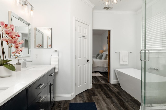 bathroom featuring hardwood / wood-style flooring, crown molding, shower with separate bathtub, and vanity