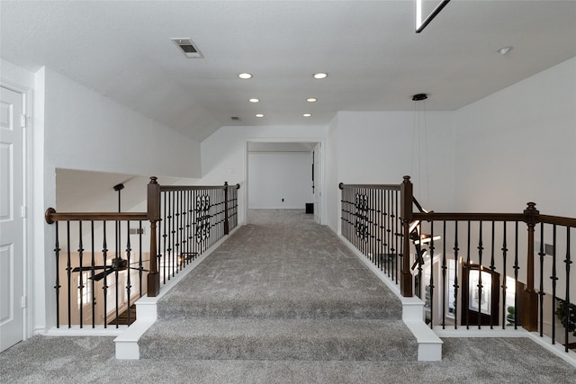 stairway with carpet flooring and recessed lighting