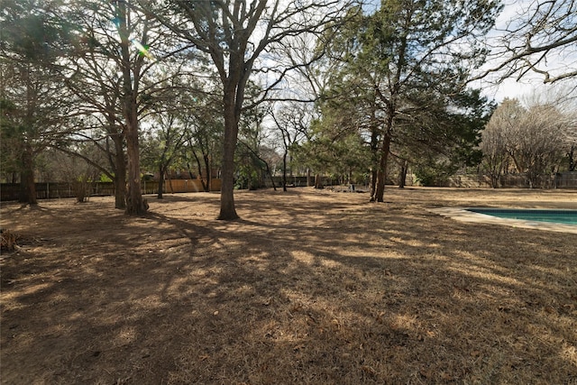 view of yard with a fenced in pool