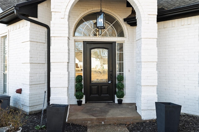 property entrance with brick siding