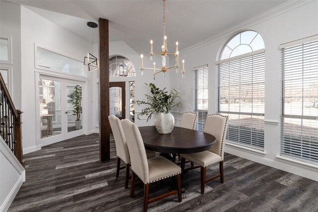 dining area featuring dark wood-style floors, a chandelier, baseboards, crown molding, and stairway