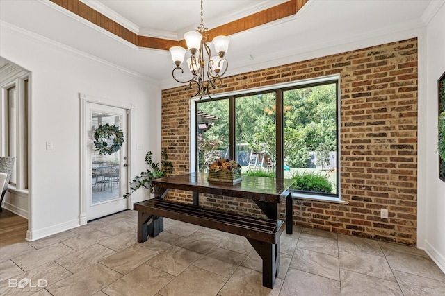 interior space with ornamental molding, a raised ceiling, a chandelier, and brick wall