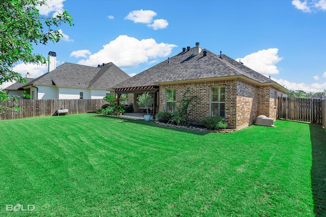 rear view of property featuring a lawn and a patio