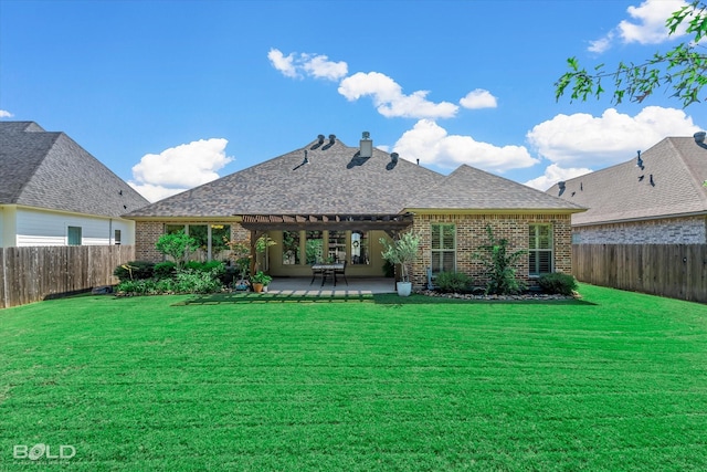 rear view of property with a yard and a patio