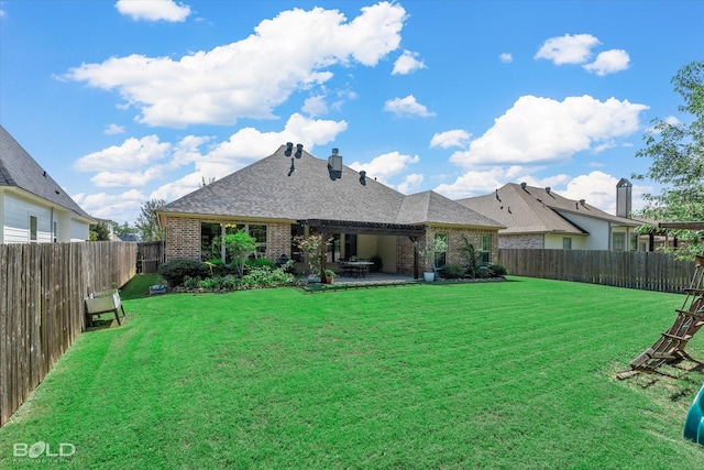 rear view of house with a patio and a lawn