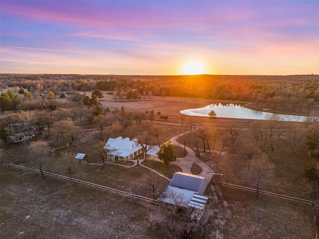 aerial view at dusk with a water view