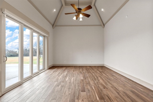 spare room with ceiling fan, high vaulted ceiling, baseboards, light wood-style floors, and beam ceiling