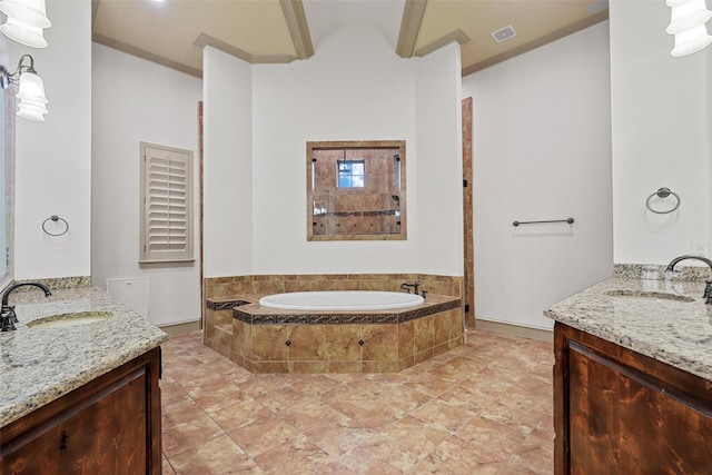 bathroom with crown molding, two vanities, a sink, and a bath