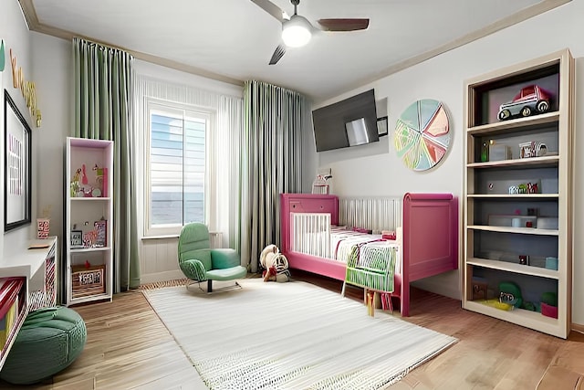 bedroom with a ceiling fan and light wood-style floors