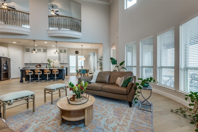 living room featuring light hardwood / wood-style flooring and ceiling fan