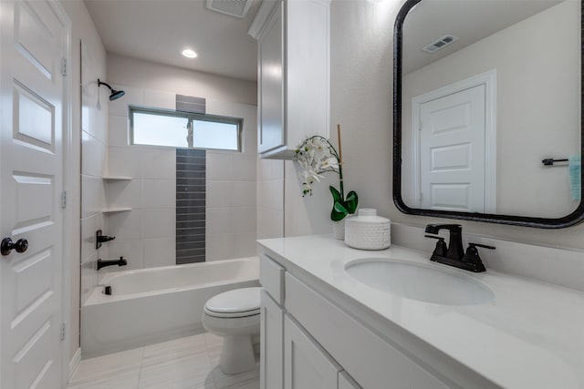 full bathroom with vanity, tiled shower / bath combo, and toilet