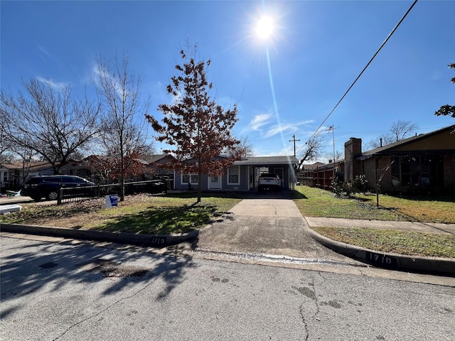 view of front of property with a carport and a front yard