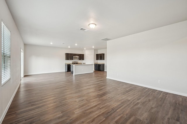 unfurnished living room with dark wood-type flooring