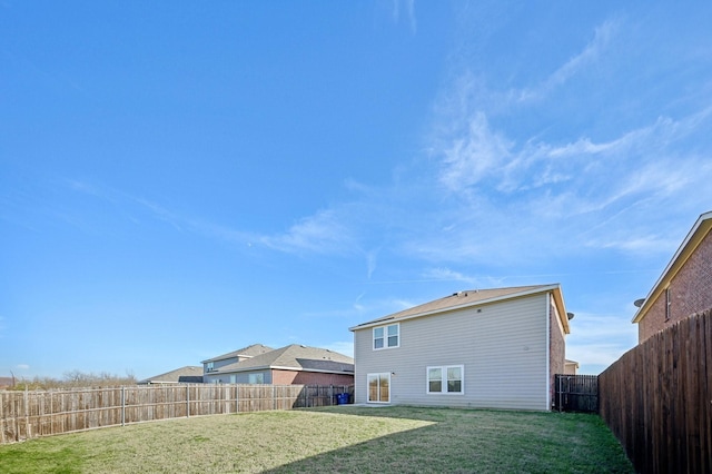 rear view of property featuring a lawn