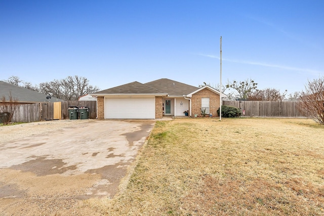 ranch-style home featuring a garage and a front yard